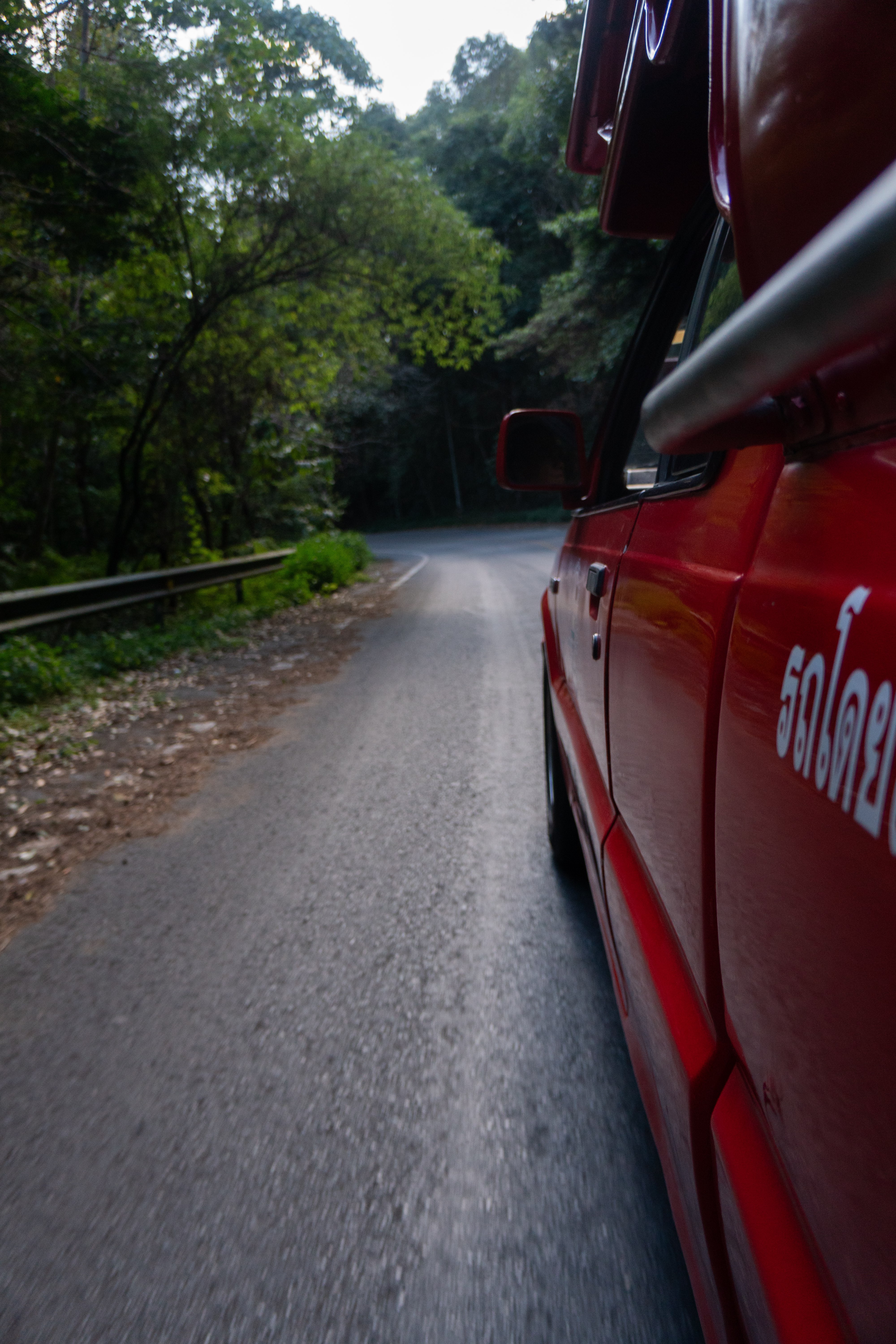 Side profile of red car in Thailand