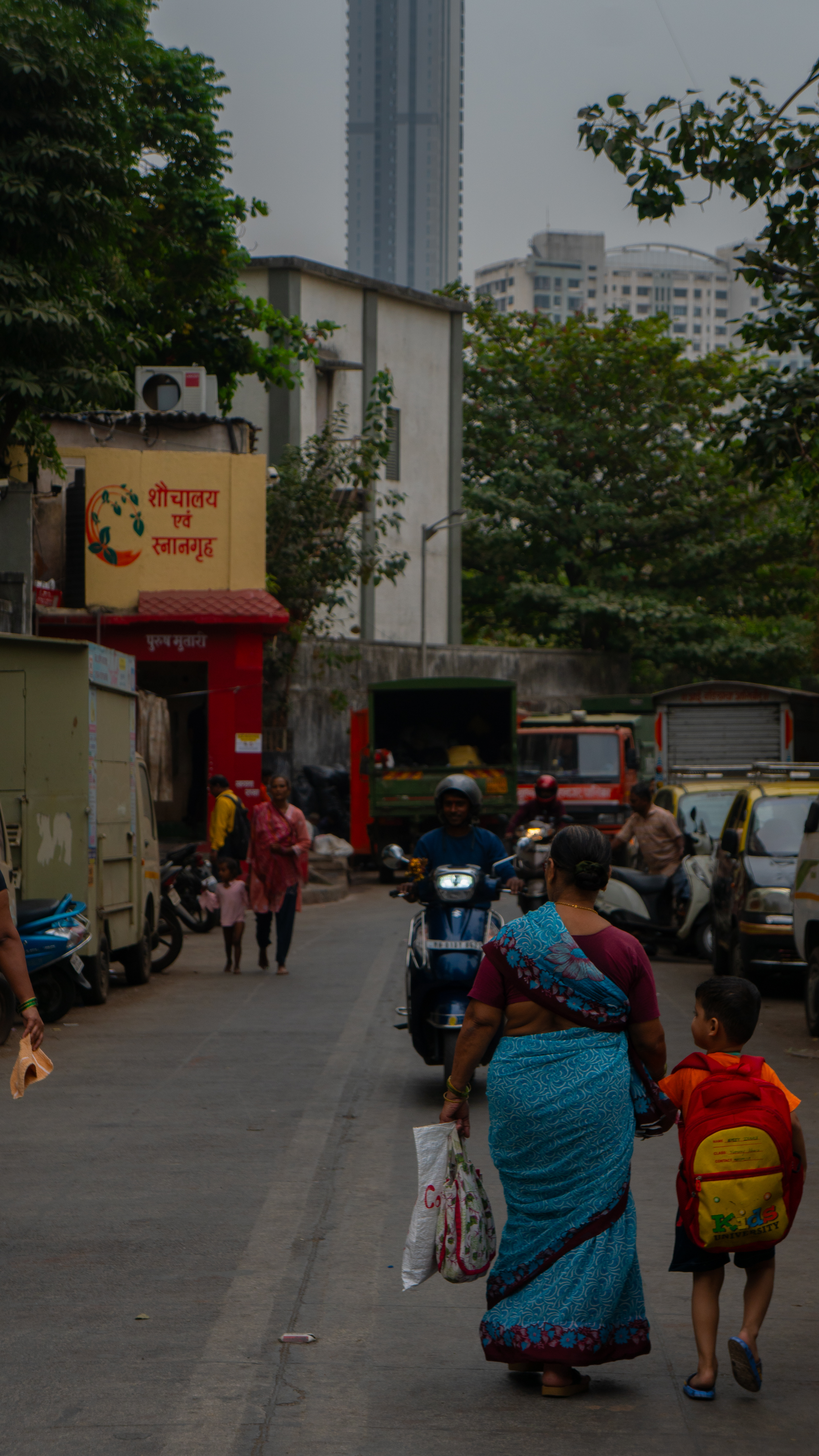 Mom walking with kid in Mumbai