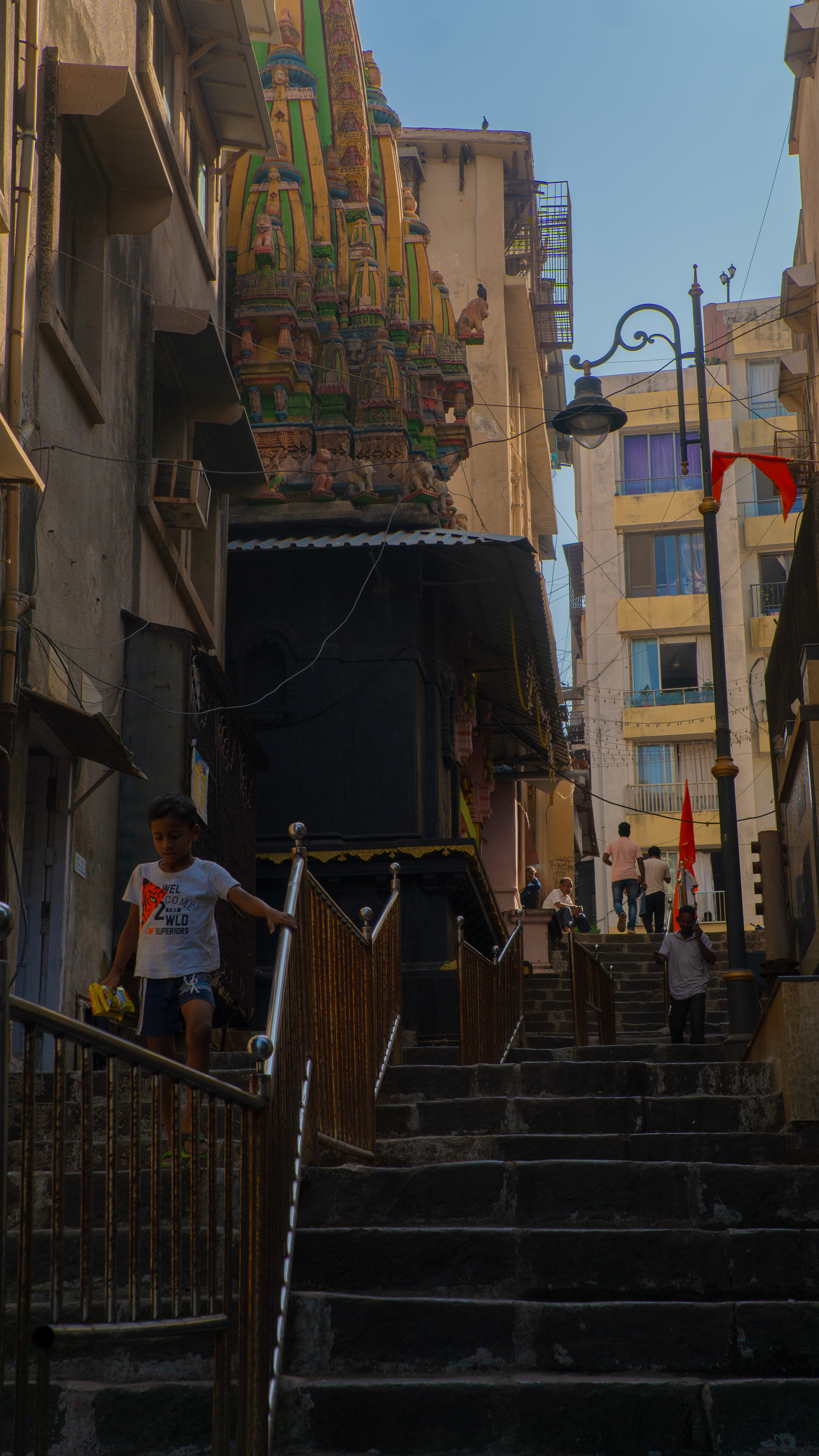 Kid walking down stairs in Mumbai