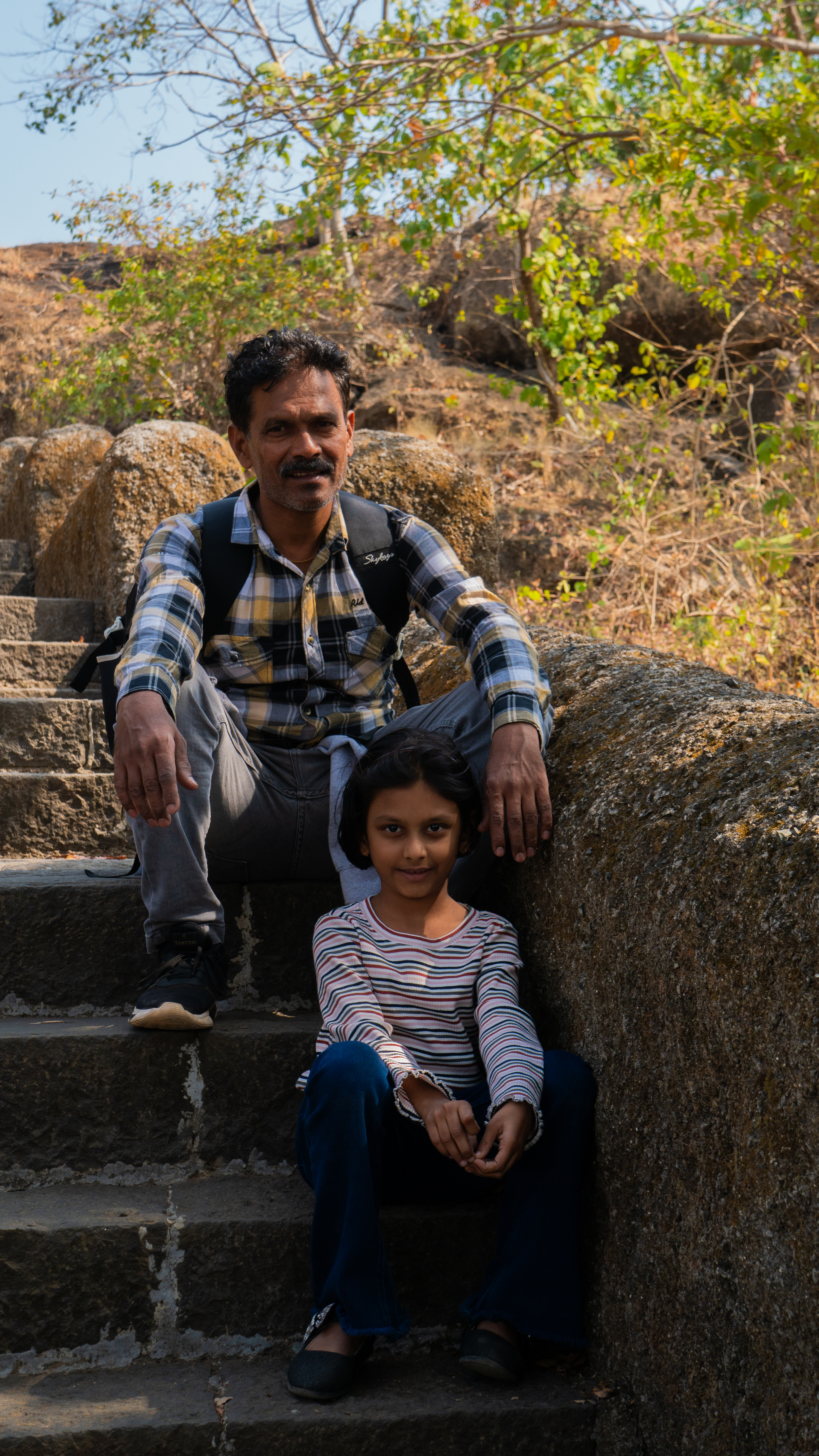 Father and daughter on steps in Mumbai