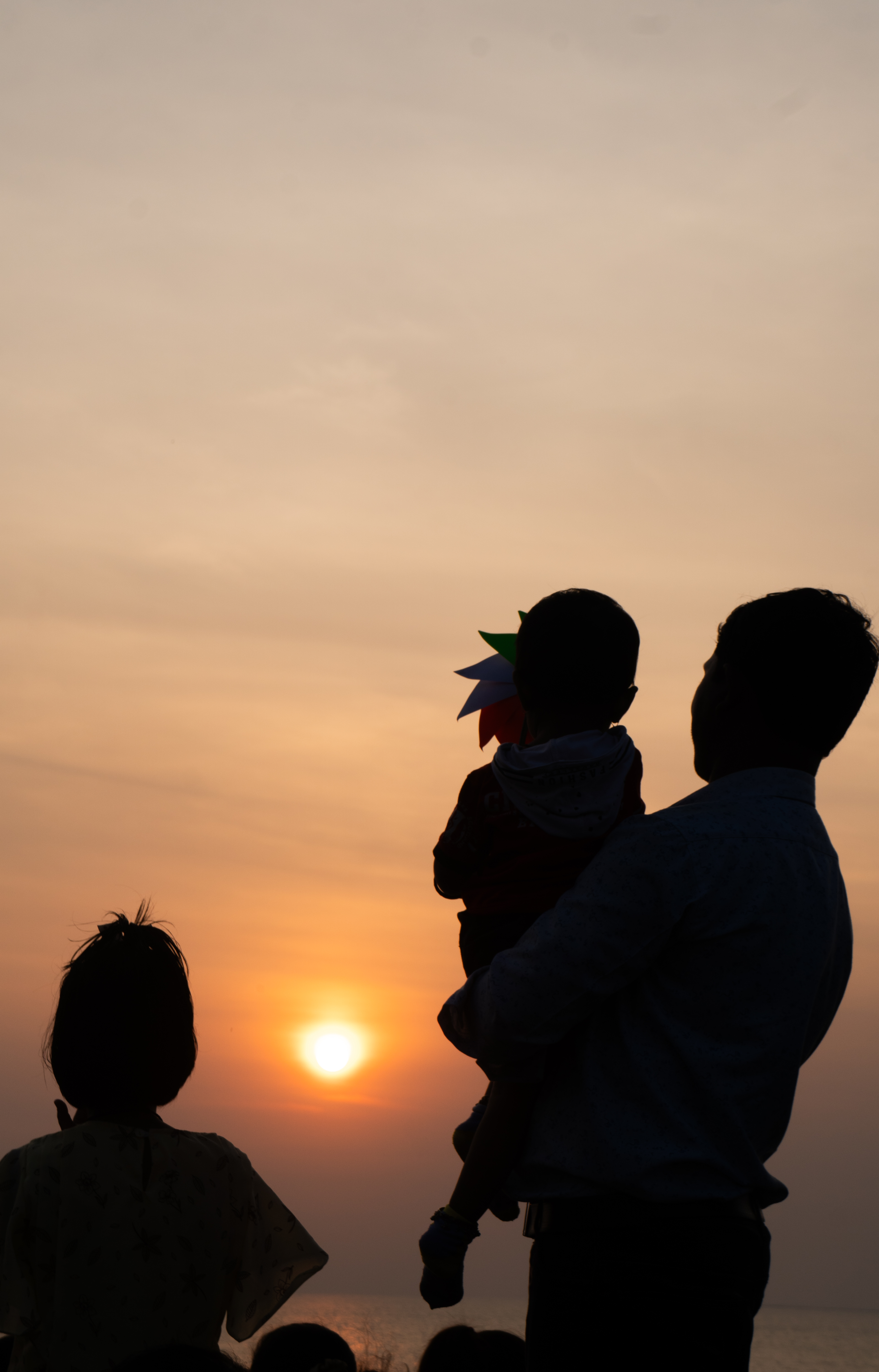 Silhouette of father and kids in Mumbai